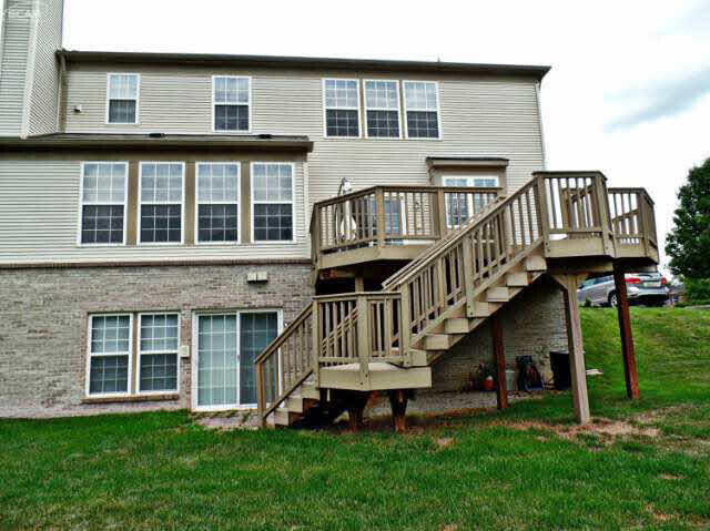 6296 Moonstone Dr, Grand Blanc, MI 48439 - rear view of property with a wooden deck, a lawn, and stairs