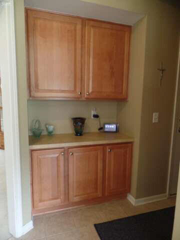 6296 Moonstone Dr, Grand Blanc, MI 48439 - kitchen with light countertops, brown cabinetry, and light tile patterned flooring