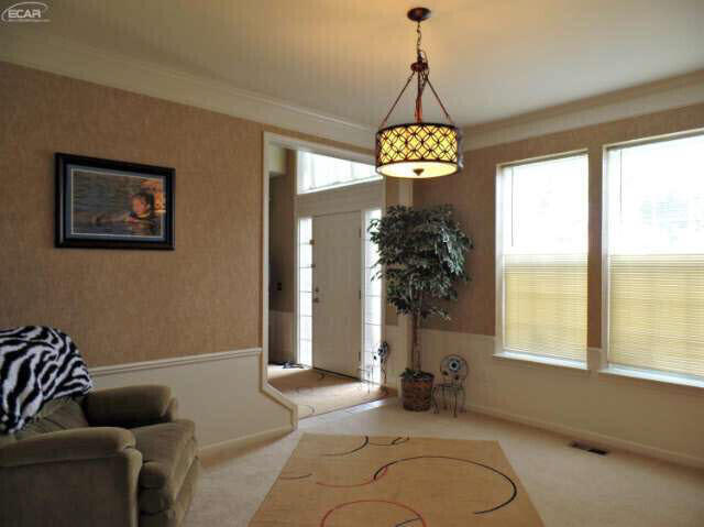 6296 Moonstone Dr, Grand Blanc, MI 48439 - foyer entrance with carpet and ornamental molding
