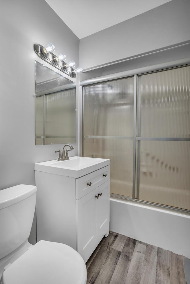 1603 Park Rd, Jackson, MI 49203 - bathroom featuring vanity, wood finished floors, and combined bath / shower with glass door
