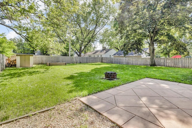 1603 Park Rd, Jackson, MI 49203 - fenced backyard featuring a patio, a storage shed, and an outdoor fire pit