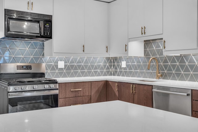 1603 Park Rd, Jackson, MI 49203 - kitchen with stainless steel appliances, light countertops, and white cabinets