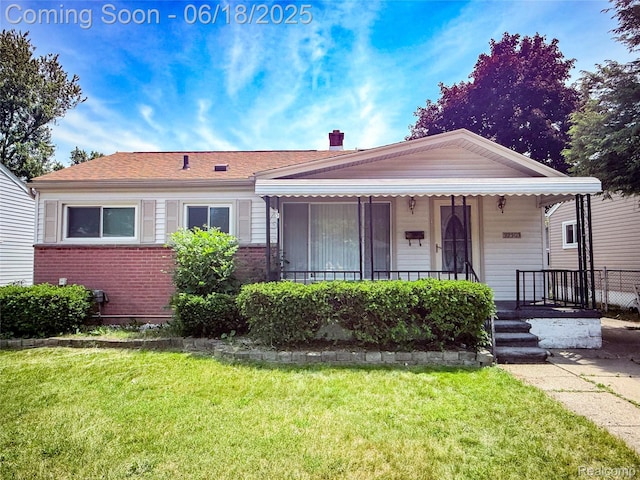 32303 Glen St, Westland, MI 48186 - view of front of property with a front yard, covered porch, brick siding, and a chimney