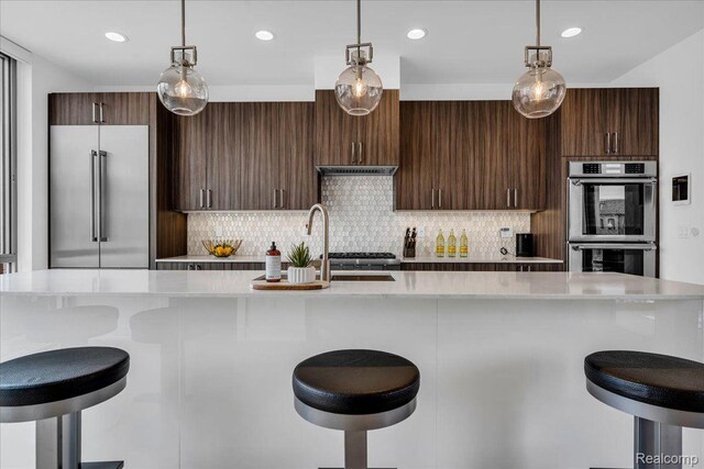 248 Alfred St, Detroit, MI 48201 - kitchen with appliances with stainless steel finishes, light countertops, tasteful backsplash, decorative light fixtures, and recessed lighting