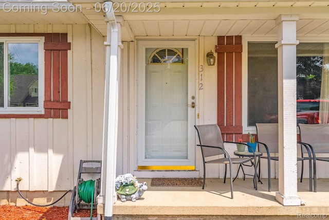 312 Airport Dr, Holly, MI 48442 - property entrance with board and batten siding and covered porch