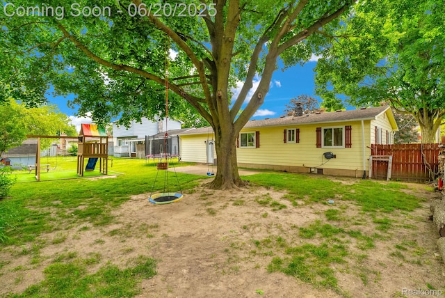 312 Airport Dr, Holly, MI 48442 - view of yard featuring a trampoline and a playground
