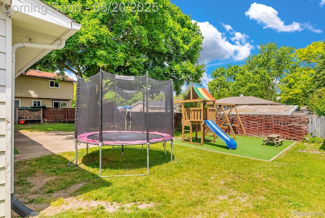 312 Airport Dr, Holly, MI 48442 - view of yard with a trampoline and a playground