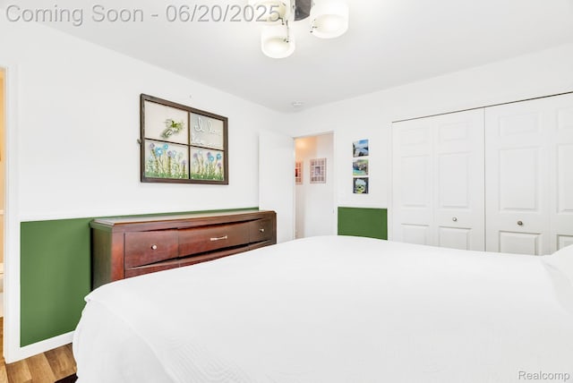 312 Airport Dr, Holly, MI 48442 - bedroom featuring a closet and wood finished floors