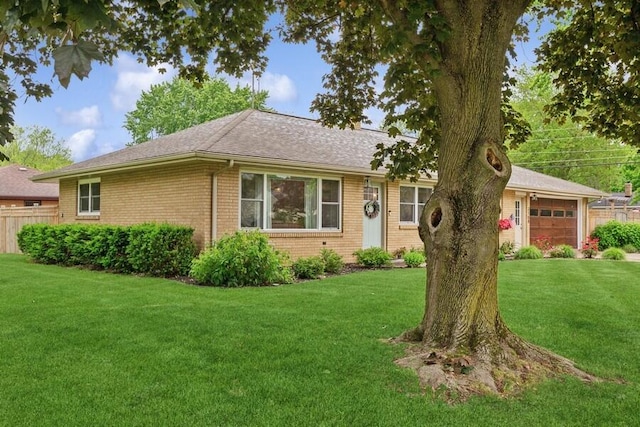 3108 Kim St, Saint Joseph, MI 49085 - ranch-style home with an attached garage, brick siding, and roof with shingles