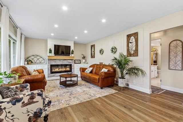 3108 Kim St, Saint Joseph, MI 49085 - living room featuring a fireplace, wood finished floors, and recessed lighting