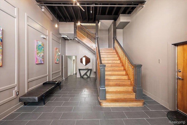 2843 E Grand Blvd Unit 4, Detroit, MI 48211 - stairway with tile patterned floors and a towering ceiling