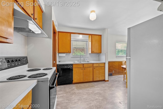 6514 Maple St, Dearborn, MI 48126 - kitchen with electric stove, black dishwasher, under cabinet range hood, light countertops, and freestanding refrigerator