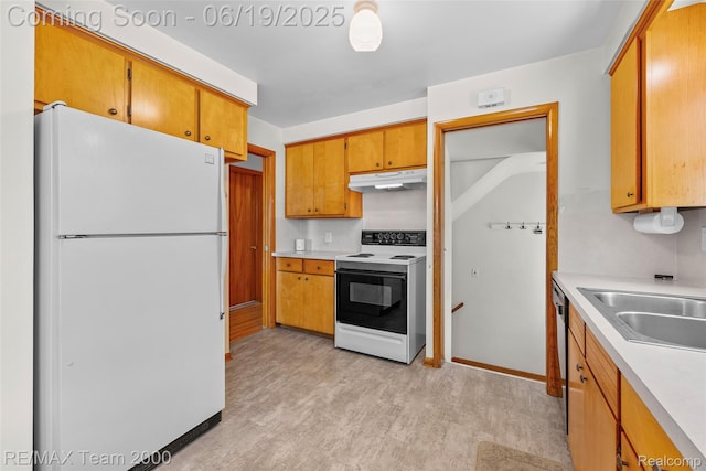 6514 Maple St, Dearborn, MI 48126 - kitchen featuring white appliances, under cabinet range hood, light countertops, light wood finished floors, and brown cabinetry