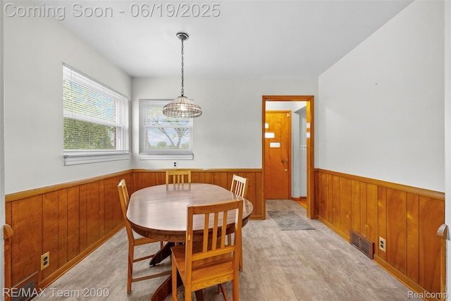 6514 Maple St, Dearborn, MI 48126 - dining area featuring a wainscoted wall, wooden walls, and light wood finished floors