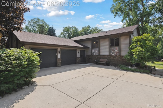 2386 Sherlock Trl, Highland, MI 48356 - view of front of home featuring an attached garage and driveway