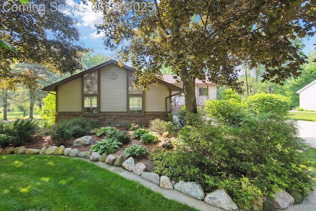 2386 Sherlock Trl, Highland, MI 48356 - view of front of home with brick siding and a front lawn