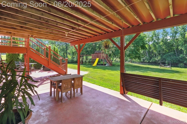 2386 Sherlock Trl, Highland, MI 48356 - view of patio / terrace featuring a playground, stairway, and view of scattered trees