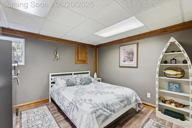2386 Sherlock Trl, Highland, MI 48356 - bedroom with wood finished floors and a drop ceiling