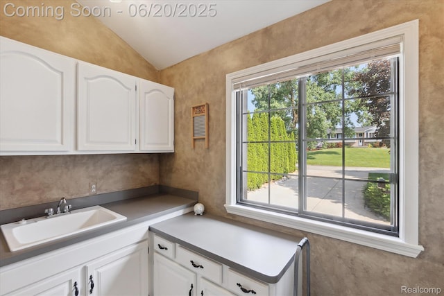 2386 Sherlock Trl, Highland, MI 48356 - kitchen featuring healthy amount of natural light, lofted ceiling, and white cabinets