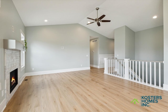 1827 Stratford Ln NW, Grand Rapids, MI 49534 - unfurnished living room featuring a ceiling fan, lofted ceiling, a fireplace, wood finished floors, and recessed lighting