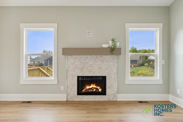 1827 Stratford Ln NW, Grand Rapids, MI 49534 - unfurnished living room with a tiled fireplace and wood finished floors