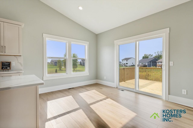 1827 Stratford Ln NW, Grand Rapids, MI 49534 - unfurnished dining area with healthy amount of natural light, lofted ceiling, light wood-type flooring, and recessed lighting