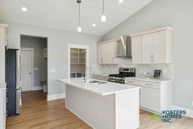 1827 Stratford Ln NW, Grand Rapids, MI 49534 - kitchen featuring stainless steel appliances, wall chimney range hood, decorative backsplash, vaulted ceiling, and a kitchen island with sink