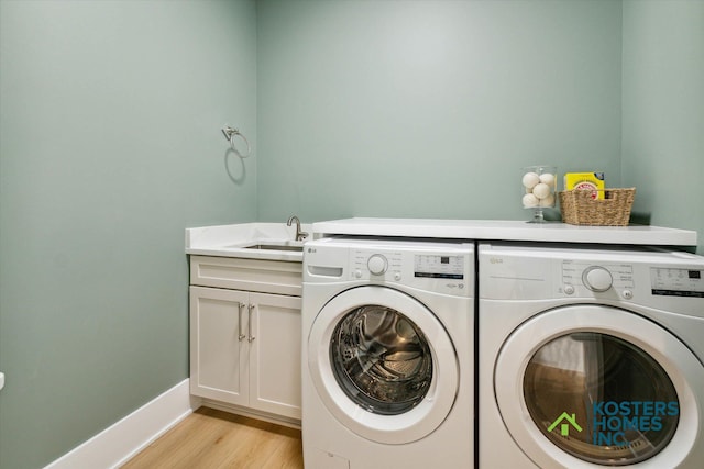1827 Stratford Ln NW, Grand Rapids, MI 49534 - washroom featuring washing machine and clothes dryer, light wood finished floors, and cabinet space
