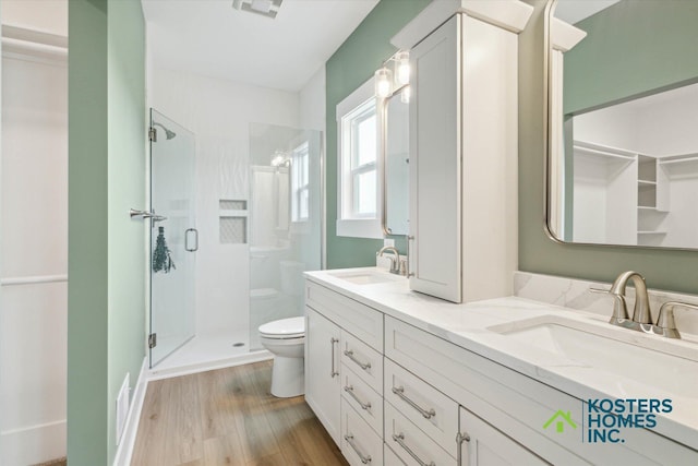 1827 Stratford Ln NW, Grand Rapids, MI 49534 - full bathroom with a stall shower, double vanity, and wood finished floors