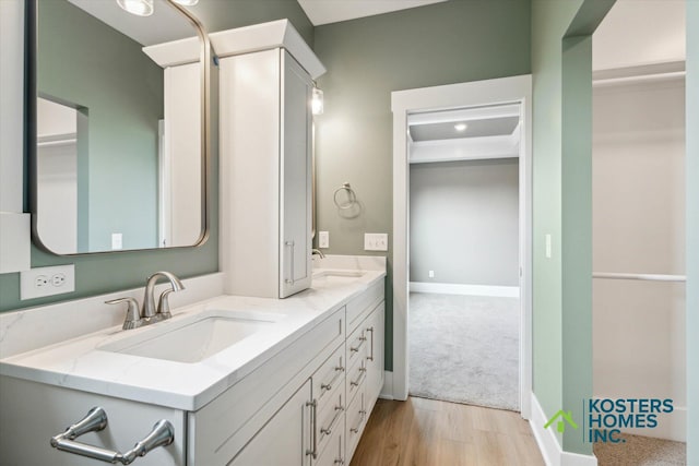 1827 Stratford Ln NW, Grand Rapids, MI 49534 - bathroom featuring double vanity and wood finished floors