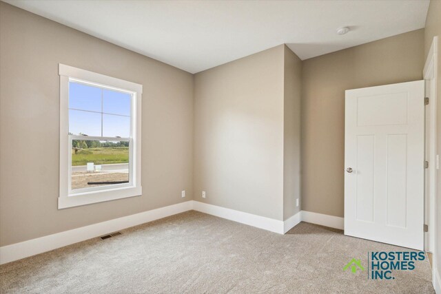 1827 Stratford Ln NW, Grand Rapids, MI 49534 - empty room with light carpet and a smoke detector