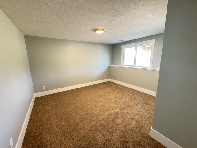1827 Stratford Ln NW, Grand Rapids, MI 49534 - empty room featuring dark carpet and a textured ceiling