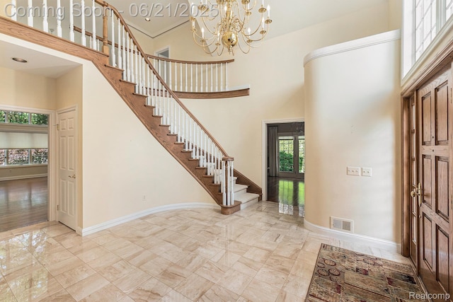 5387 Bristol Parke Dr, Clarkston, MI 48348 - foyer entrance with a high ceiling, stairs, marble finish flooring, and a chandelier