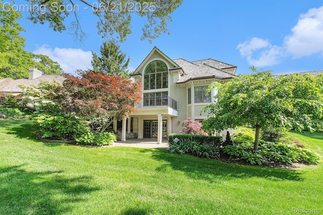 5387 Bristol Parke Dr, Clarkston, MI 48348 - back of house with a lawn, stucco siding, and a patio