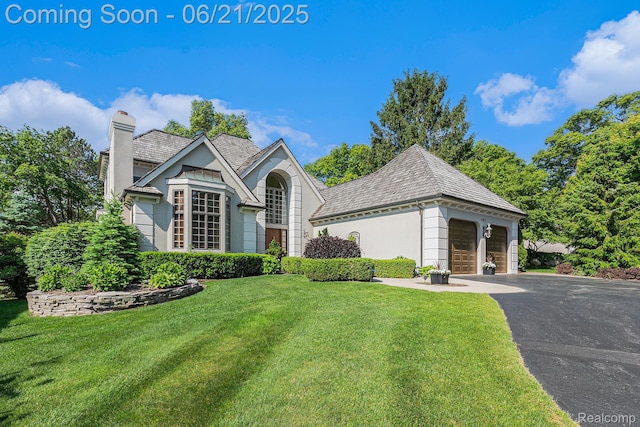 5387 Bristol Parke Dr, Clarkston, MI 48348 - view of front facade featuring a chimney, a high end roof, and a front lawn