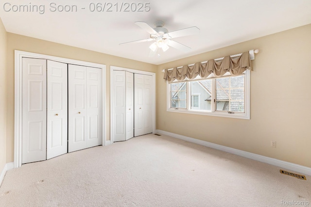 5387 Bristol Parke Dr, Clarkston, MI 48348 - unfurnished bedroom with two closets, carpet, and a ceiling fan