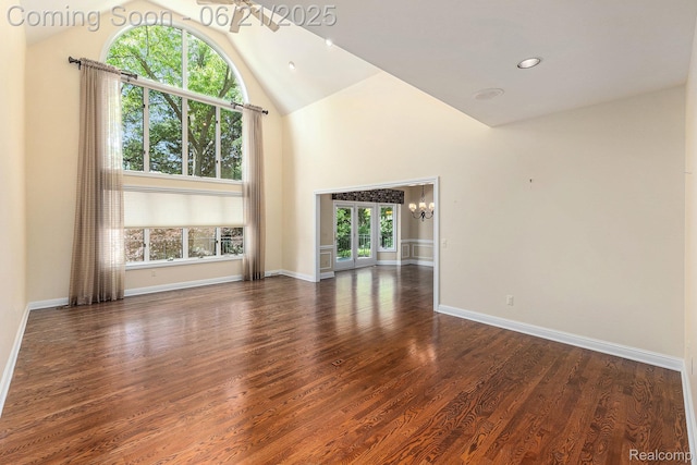 5387 Bristol Parke Dr, Clarkston, MI 48348 - unfurnished living room with a chandelier, high vaulted ceiling, and wood finished floors
