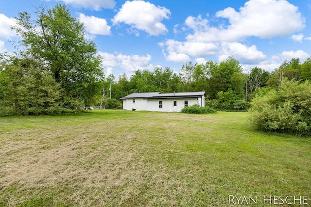 10340 Kartz Rd, Greenville, MI 48838 - view of grassy yard featuring a forest view