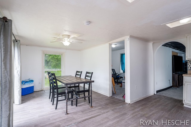10340 Kartz Rd, Greenville, MI 48838 - dining space with arched walkways, wood finished floors, and ceiling fan