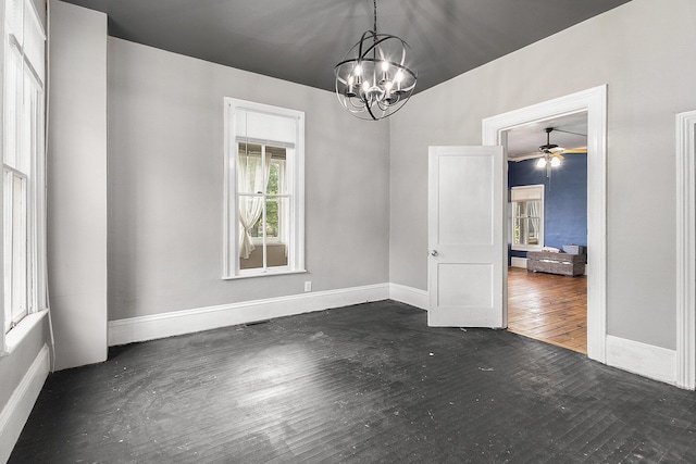 390 W Muskegon Ave, Muskegon, MI 49440 - unfurnished room with a chandelier, dark wood-style floors, and ceiling fan