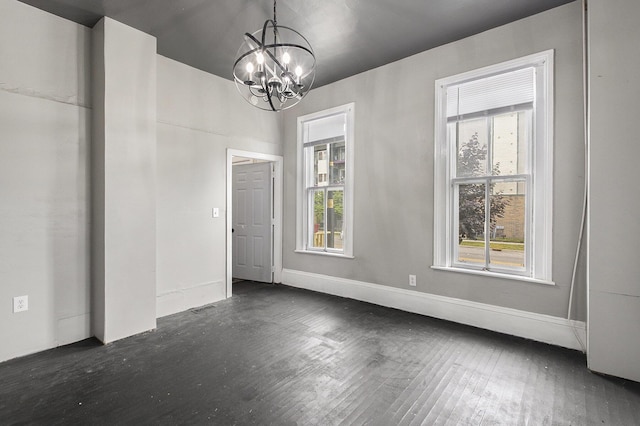 390 W Muskegon Ave, Muskegon, MI 49440 - unfurnished dining area featuring a chandelier and dark wood-style flooring