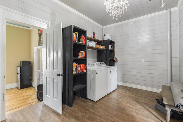 390 W Muskegon Ave, Muskegon, MI 49440 - laundry area featuring washing machine and clothes dryer, crown molding, wood finished floors, a chandelier, and wood walls