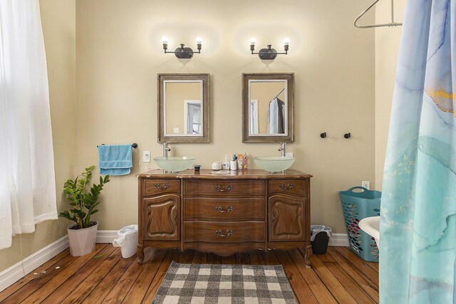 390 W Muskegon Ave, Muskegon, MI 49440 - full bathroom with hardwood / wood-style flooring, double vanity, and a freestanding tub