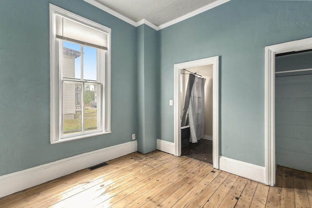 390 W Muskegon Ave, Muskegon, MI 49440 - unfurnished bedroom with crown molding and light wood finished floors