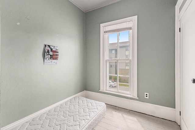 390 W Muskegon Ave, Muskegon, MI 49440 - bedroom featuring light wood-style floors and crown molding