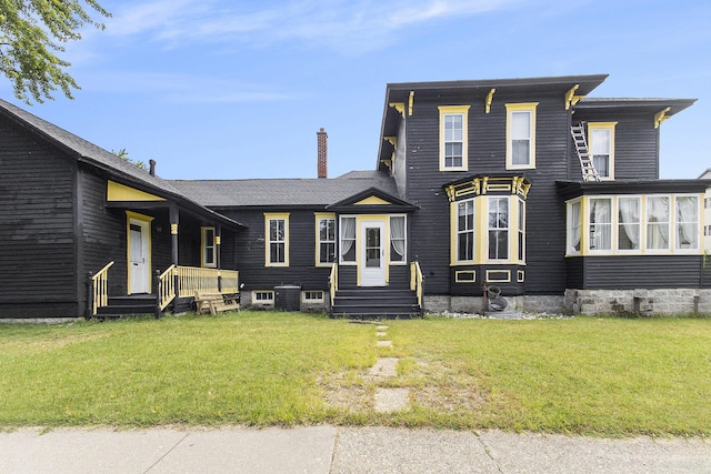 390 W Muskegon Ave, Muskegon, MI 49440 - view of front of home with a front lawn and a chimney