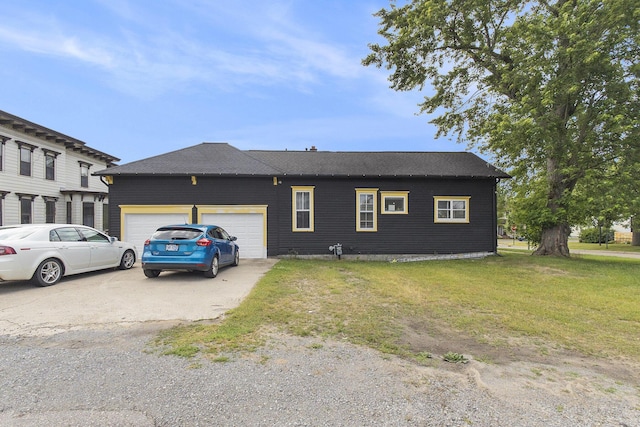 390 W Muskegon Ave, Muskegon, MI 49440 - view of front of home with a front lawn, an attached garage, and concrete driveway