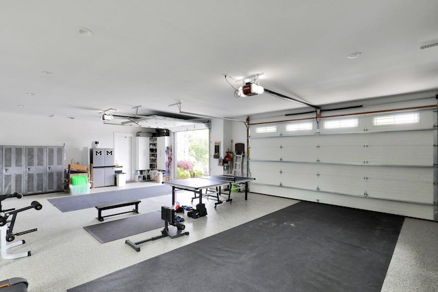 7074 S Ainger Rd, Olivet, MI 49076 - garage with freestanding refrigerator and a garage door opener