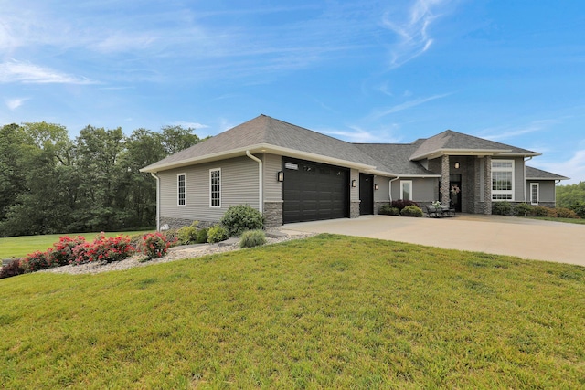 7074 S Ainger Rd, Olivet, MI 49076 - view of front facade with an attached garage, stone siding, concrete driveway, a front yard, and roof with shingles