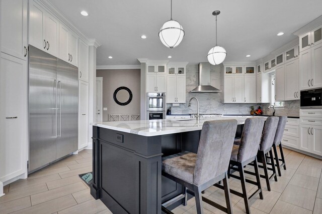 7074 S Ainger Rd, Olivet, MI 49076 - kitchen featuring wall chimney exhaust hood, stainless steel appliances, crown molding, backsplash, and white cabinets